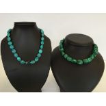 2 necklaces made of semi-precious stones: 1) String of polished irregular malachite stones. 2)