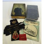 A collection of Royal Navy items to include 2 Seamanship manuals & uniform flashes & badges.