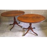 A pair of small oval occasional tables with pedestal legs with brass claw feet and casters. Measures