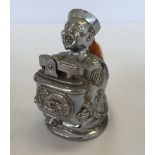 A Mandarin gentleman shaped table lighter.