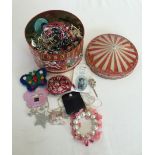 A carousel tin containing a good quantity of childrens jewellery.