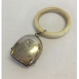 An Edwardian silver babies rattle with ivory teething ring. Birmingham 1906.