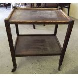 A vintage wooden tea trolley.