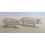 2 white Beswick ceramic pigs. Wall Boy 53 and Wall Queen 40.