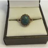 A 9ct gold and green stone ring with a twist decoration. Size M, total weight approx 3.2g