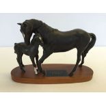 A Beswick connoisseur model of 'Black Beauty and foal' in black matte finish on a wooden plinth.