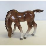 A large brown foal grazing figurine by Lomonosov. Approx 20cm high with red "Made in USSR"