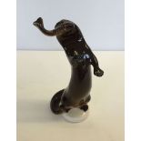 A Lomonosov otter figurine, approx 21cm high, with red "Made in Russia" backstamp.