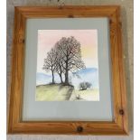 A framed and glazed watercolour of trees on a hill signed D Tate '83. Approx size 24.5 x 29cm