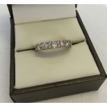 Hallmarked 9ct gold half eternity ring set with 5 large round cubic zirconias and 8 small cubic