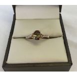 Pretty smoked quartz dress ring with 9ct gold shank. Size N. 3 small diamonds down each shoulder.