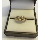 A 9ct gold celtic knot ring. Size N1/2. Approx weight 1.8g.