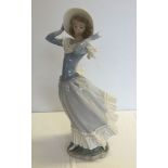 A Lladro windswept lady figure approx 35cm tall.