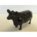 A Beswick black Aberdeen Angus cow with Gold backstamp. Marked "Approved by the Aberdeen Angus