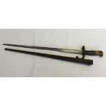 An antique French gras bayonet with scabbard. Blade has engraving. 1879.