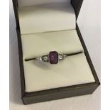 A 9ct gold and silver dress ring set with Amethyst and clear stones. Size Q.