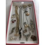 A small quantity of costume jewellery to include necklaces and brooches.