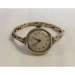 A 9ct gold ladies wristwatch, hallmarked on outside of case, on a 9ct gold strap. In working order.