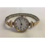 A 9ct gold cased ladies wristwatch hallmarked inside case with a rolled gold strap. In working