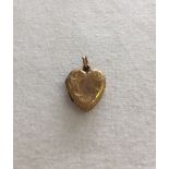 A small heart shaped 9ct gold locket with engraved design approx weight 1.6g.