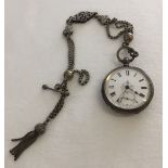 An ornately engraved ladies pocket watch marked 800 silver a/f together with a decorative white