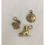 3 9ct gold charms. A squirrel, a St. Christopher and an ice skate. Total weight approx 2.4g.