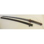 A 1936 Japanese Samurai sword and scabbard with a Ray skin handle, bronze mounts and a signed