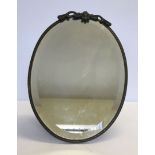 An Art Nouveau oval table mirror with bevelled edge glass and painted bead decoration.