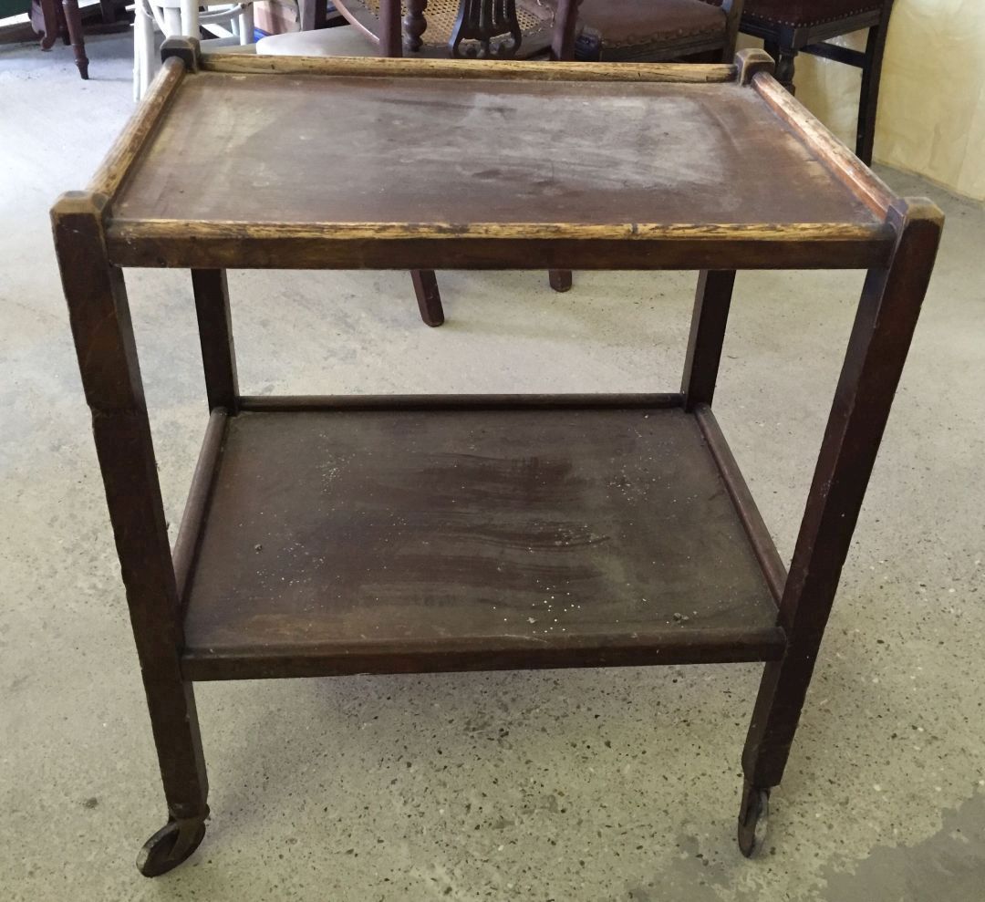 A vintage wooden tea trolley.