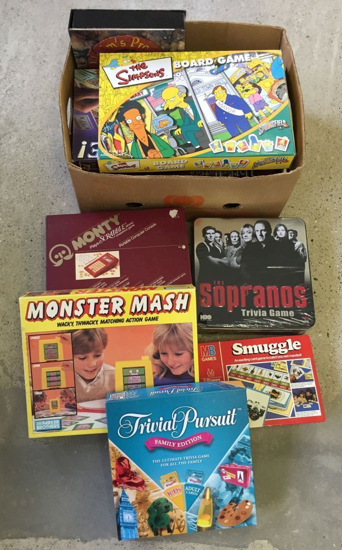 A box of board games including sealed example, and a glass top chess board.