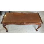 A vintage oak coffee table with brown leather insert top and glass cover