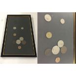 A framed and glazed collection of British coins from 1950.