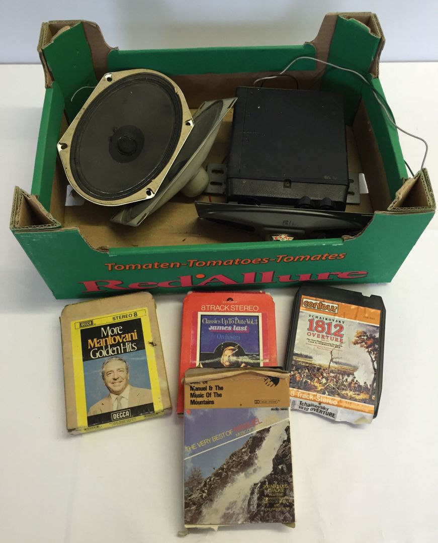 A vintage stereo 8 solid state 8 track player with 3 speakers and 4 tapes.