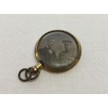 Bevelled edge glass photo pendant with rolled gold mount. Featuring photos of a WW1 soldier with