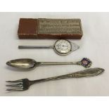A boxed universal map measurer together with a pickle fork & an enamelled city livery club spoon.