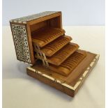 A musical cigarette dispenser box inlaid with bone and mother of pearl.