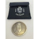 A Canadian silver proof confederation coin in presentation wallet.