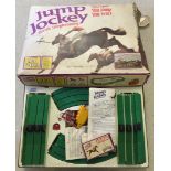 A vintage Tri-ang 'Jump Jockey' horse racing game (Scalextric style). With 4 electric horses.