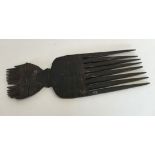 An African tribal head comb.