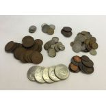 A collection of assorted vintage coins to include British six pences, 5 Churchill crowns, 1940s