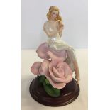 A ceramic figure on wooden base 'Lady Rose' by Jegou made by the Franklin Mint.