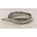 Hallmarked silver hinged bangle. Weight approx 24.3g. Engraved inside 'Sylvia love Garnham 1962'.