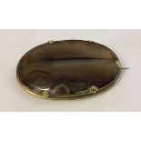 Large oval agate brooch set in a gold plated mount. Measures approx 5.5cm x 3.5cm.