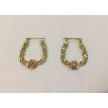 A pair of decorative hoop design earrings in 9ct yellow gold with rose gold flowers, total weight