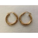 A pair of twisted hoop 9ct gold earrings. Weight approx 1.6g.