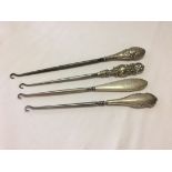 Four silver handled button hooks. Hallmarked Birmingham, various dates and manufacturers. Between
