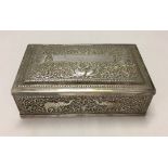 Indian silver cigarette case with wooden liner. The case is engraved with elephants and other