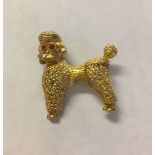 Hallmarked 9ct gold poodle brooch with rubies set as eyes. Measures approx 2.5cm x 3cm, weight