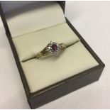 Hallmarked 9ct gold ring with central ruby surrounded by diamonds. Pretty diamond shaped mount on