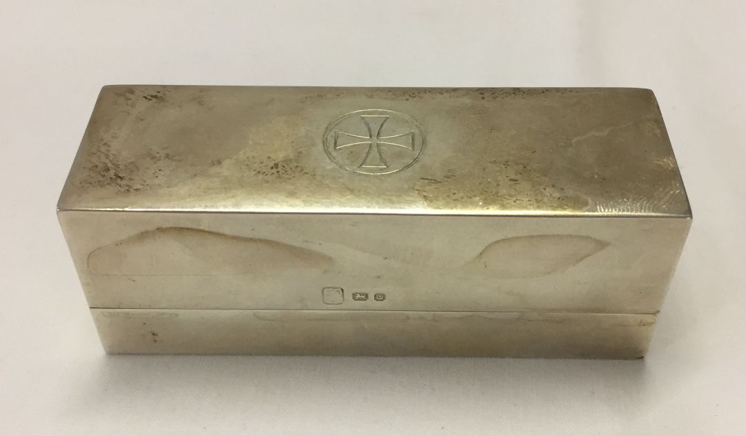 A rectangular lidded silver case. Cross in circle to lid, hallmarked London 1951. Weight approx